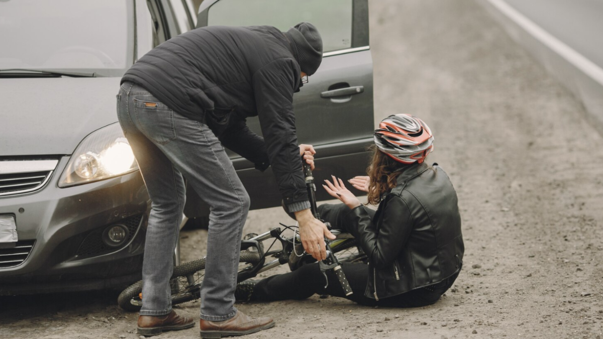 A head-on collision between a car and a cyclist.