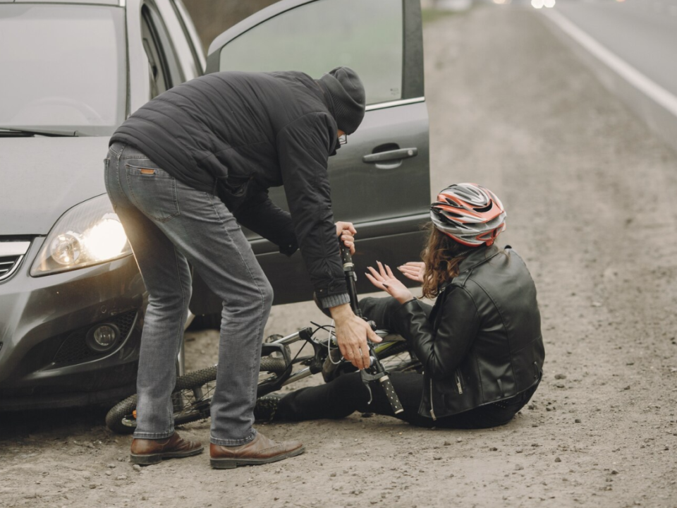 A head-on collision between a car and a cyclist.