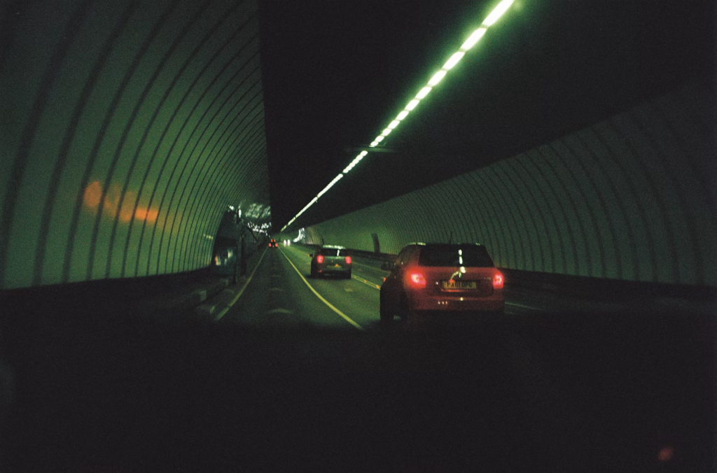 Multiple vehicles driving correctly in their respective lanes on a multi-lane highway.