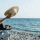 A car parked on a sandy beach with the ocean in the background.