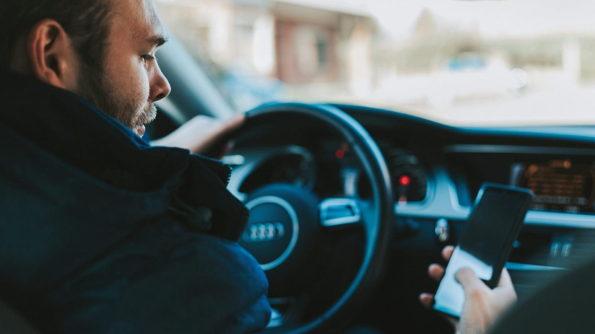 A man using his phone while driving