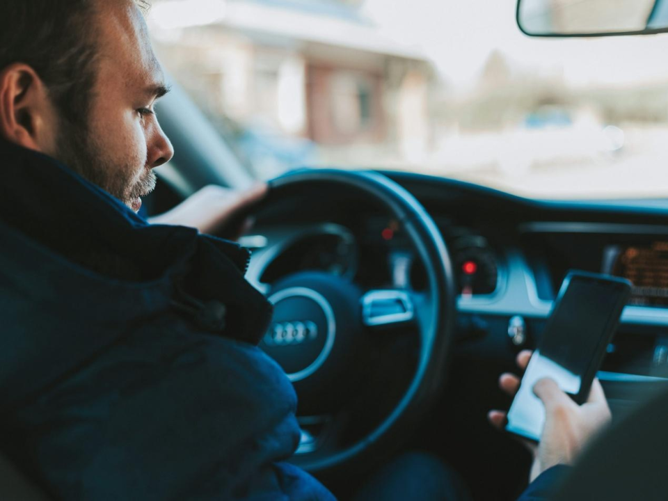 A man using his phone while driving