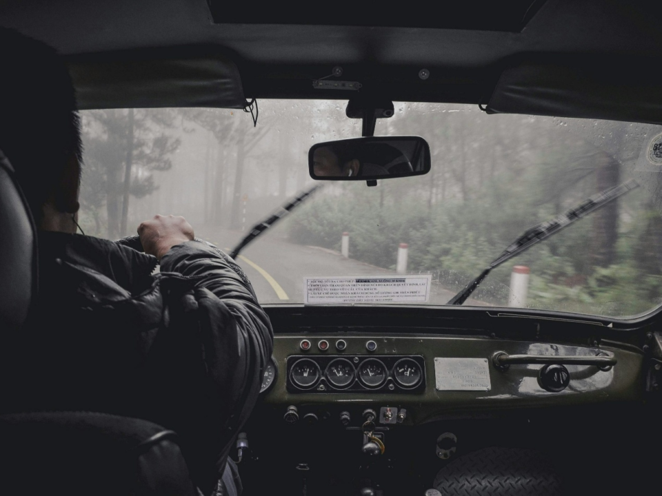 A man driving a car in the rain