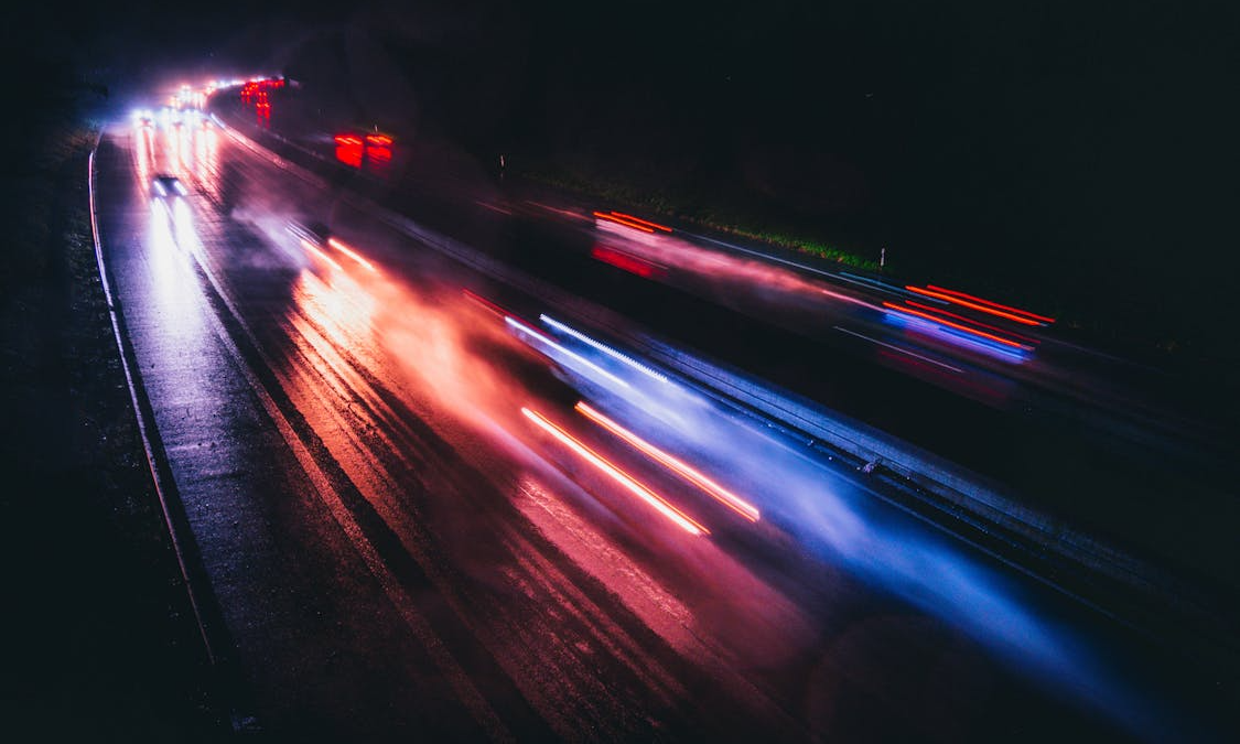Long exposure of motor vehicle light streaks on a busy road at night