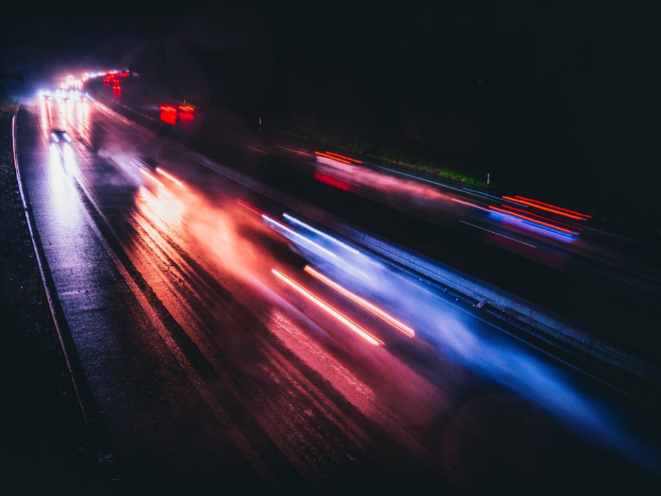 Long exposure of motor vehicle light streaks on a busy road at night