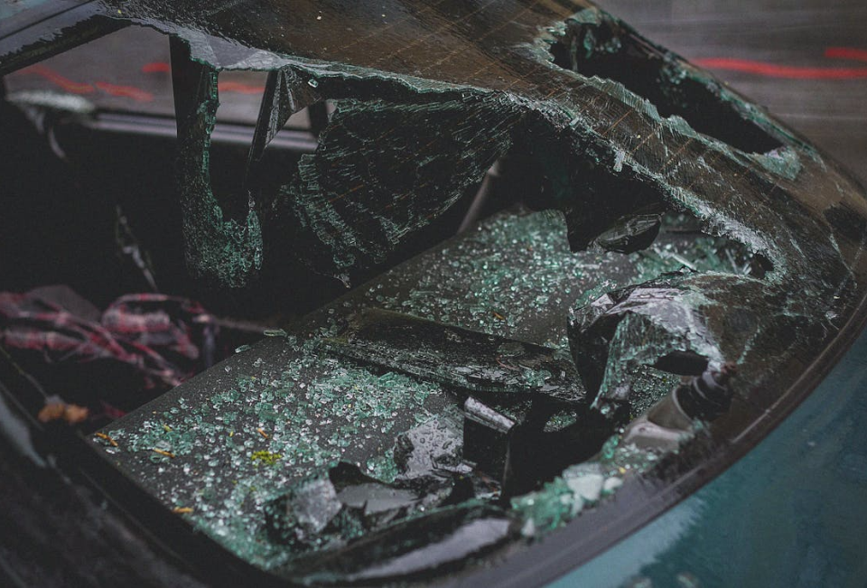 Close-up of a car with a severely cracked and shattered windshield